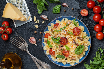 Italian pasta with sauce, cherry tomatoes, basil and parmesan cheese. Delicious pasta plate. Vegan pasta. 