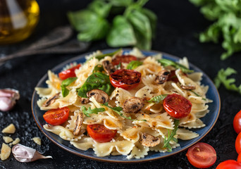 Italian pasta with sauce, cherry tomatoes, basil and parmesan cheese. Delicious pasta plate. Vegan pasta. 