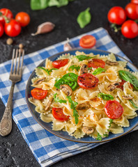 Italian pasta with sauce, cherry tomatoes, basil and parmesan cheese. Delicious pasta plate. Vegan pasta. 