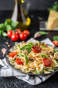 Italian pasta with sauce, cherry tomatoes, basil and parmesan cheese. Delicious pasta plate. Vegan pasta. 