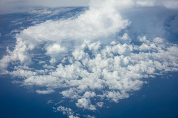 Cloudy sky background. View out of an airplane window.