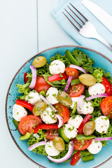Vegetable salad with cheese mozzarella, tomatoes, basilikum and spice.