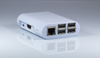 RJ45 and USB ports of tiny computer. On mirror table.