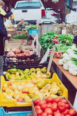 Tomatoes at the summer outdoor farmers market. Healthy and local food and community concept