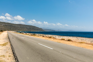 Fototapeta na wymiar empty road to guantanamo with the ocean Cuba