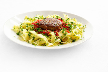 fried turkey meatball with pasta and tomato sauce sprinkled with parsley