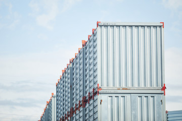 Fototapeta premium Top row of new metallic storage containers somewhere by load and transportation factory