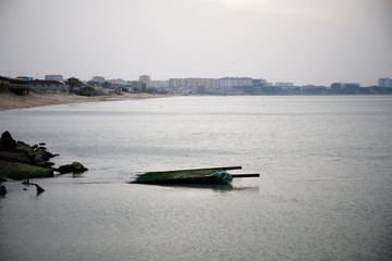 Obraz premium Beautiful landscape of abandoned house on rocky seashore at sunset time. Cloudy weather. Caspian Sea, Azerbaijan