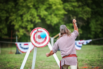 Man throwing an ax at a target
