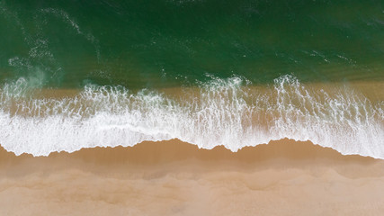 Aerial shot of waves and beach in Aveiro, Portugal