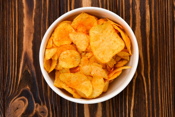 Chips on a wooden table. Space for text or design. Top view.
