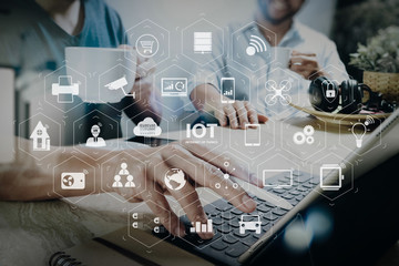 co working website designers working at office and holding a cup of coffee,working on smart phone and digital tablet computer docking on smart keyboard,filter film effect