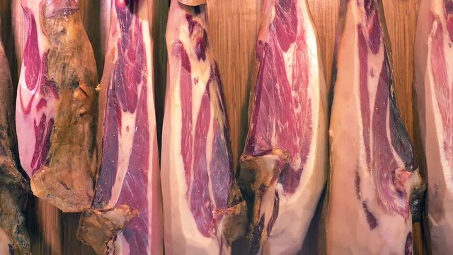 Dry-Cured Ham (Jamon) cuts in La Boqueria market, Barcelona - Dolly shot