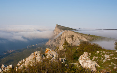 Fototapeta na wymiar Above the clouds: foggy morning in Crimean mountains in spring