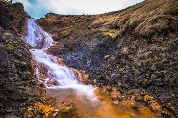 Naklejka na ściany i meble Hvitserkur - May 08, 2018: Waterfall at Hvitserkur, Iceland
