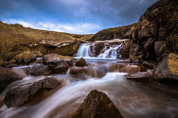 Icelandic wilderness - May 08, 2018: Small waterfall in the icy wilderness of Iceland