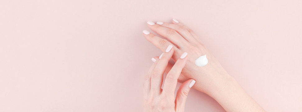 Woman Moisturizing Her Hand With Cosmetic Cream