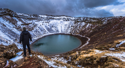 Kerid Crater- May 04, 2018: Traveler at the The Kerid Crater in the Golden Circle of Iceland