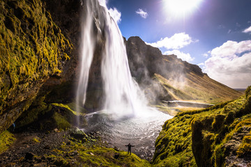 Fototapeta premium Seljalandsfoss - May 04, 2018: Traveler at the Seljalandsfoss waterfall, Iceland