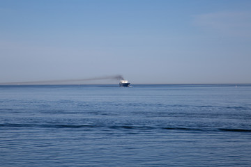 Beautiful ocean view with blue sky and transport ship
