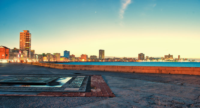 view of the malecon in the city of Havana at sunset in Cuba
