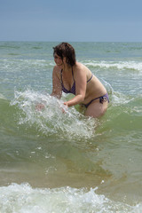 woman enjoys the waves