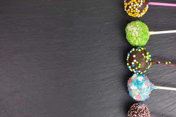 cake pops with a variety of brightly colored sprinkles