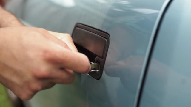 Male Mechanic Holding Lockpicker To Open Car Door