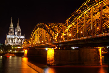 Fototapeta premium The view over the river Rhine with the Hohenzollern Bridge and the Cathedral at night is one of the most impressive views in Cologne, Germany 