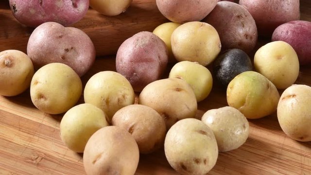 Multi-colored tiny potatoes on a cutting board