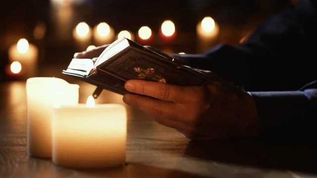 Man reading the Holy Bible and praying in the Church
