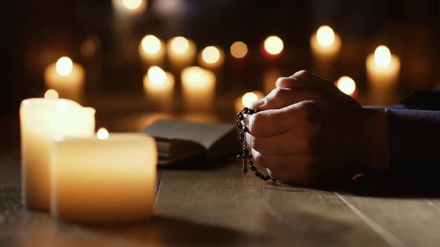 Man praying the Holy Rosary in the Church