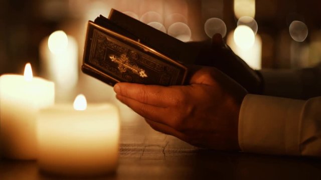 Man reading the Holy Bible and praying in the Church