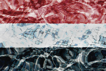 Texture of  Yemen  flag in the pool, water. Splashes.