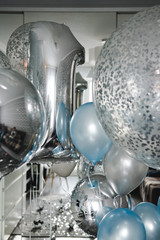 Birthday party in blue and silver. Many different balloons