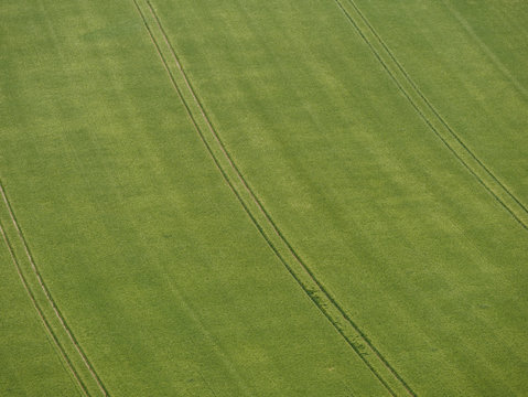 Top down view on farmland with tractor tracks