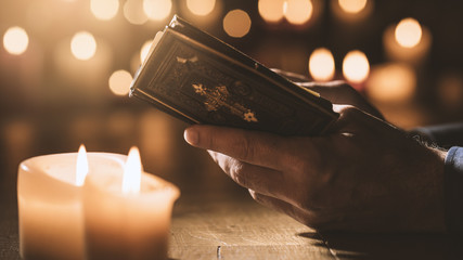 Man reading the Holy Bible and praying in the Church