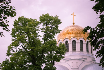 Golden dome of the Orthodox church in Central Russia on the blue sky background