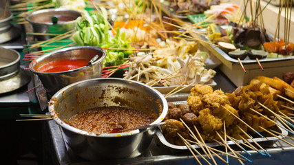 Asian street Food. People cooking, selling and buying Exotic Asian Food
