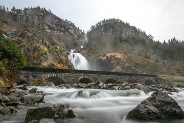 Fototapeta na wymiar Stone bridge river waterfall Låtefossen Norway