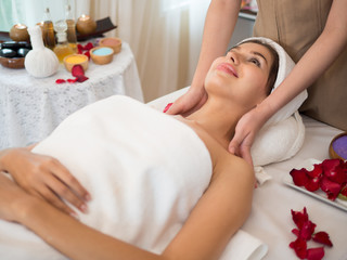 Obraz na płótnie Canvas image of Beautiful young woman receiving massage in spa salon