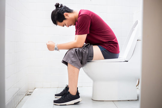 Man sitting in toilet.Diarrhea concept.