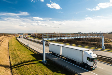 White lorry passing toll gate on Prague Circuit, Czech republic