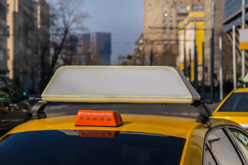 City taxi moves along city street.