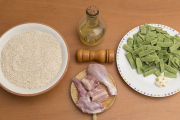 composition with ingredients to cook a rice with chicken and rabbit