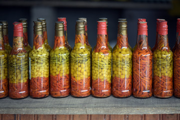 Canned pepper bottles on market stall