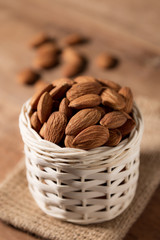 Almond snack fruit in white basket on wooden