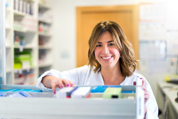 Woman customer in the pharmacy taking a medicine box