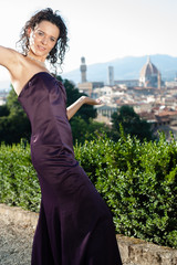 Young brunette girl acting as a robot. Sunny day, Florence Italy