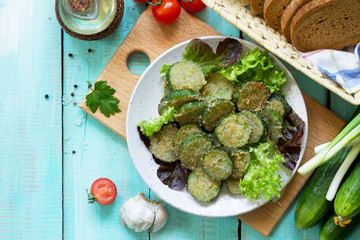 Fried zucchini or cucumber. Fast food on the kitchen table. Top view flat lay background.